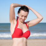 ShowBee SwimIt bikini top in fire red color with golden rings.
