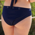 ShowBee SwimIt bikini briefs in navy blue with silver rings, for attaching the ShowBee Fantasies. View from the back.