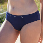 ShowBee SwimIt bikini briefs navy blue, decorated with silver rings, which can be used to attach the ShowBee Fantasies. Front view.