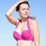 ShowBee SwimIt bikini top in beautyberry rose color with golden rings.